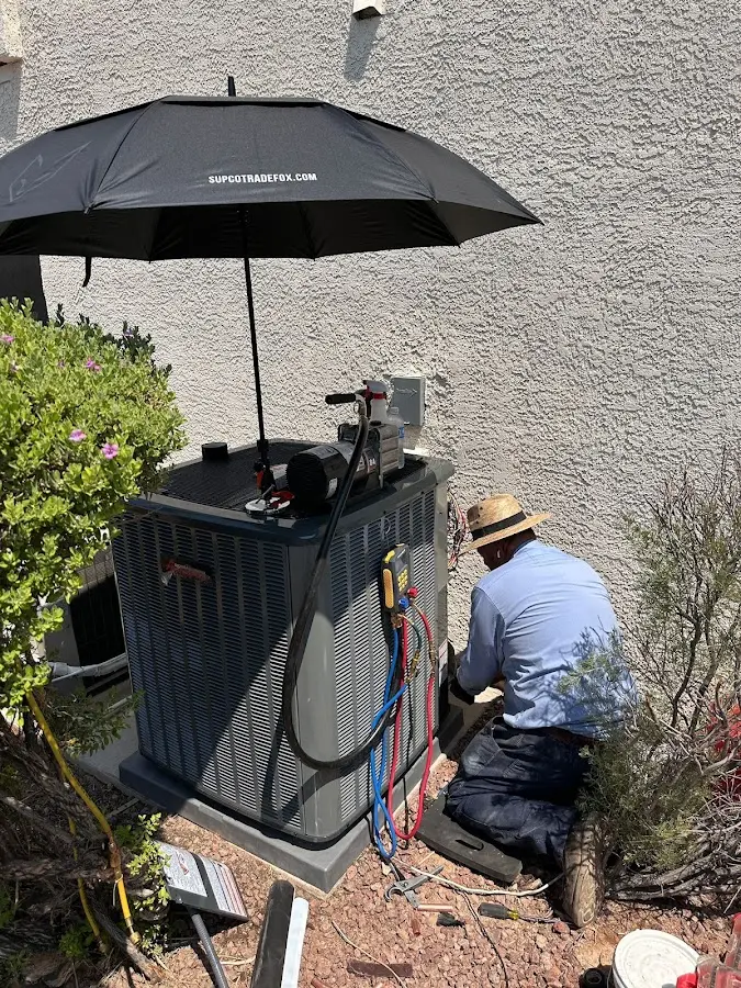 HVAC technician performing outdoor AC maintenance in Whitehouse